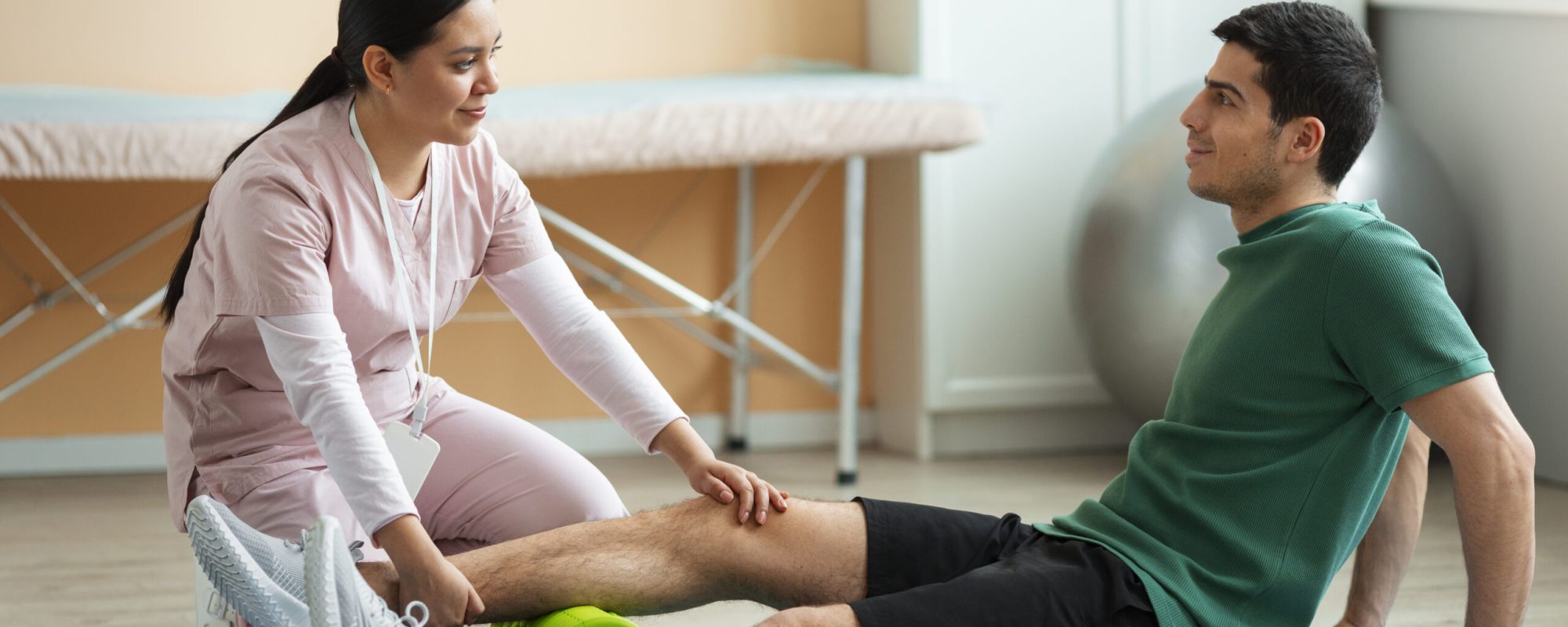 doctor-helping-patient-rehabilitation