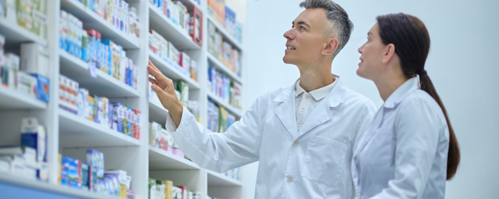 Inventory. Two druggists in lab coats in the process of inventory in a drugstore